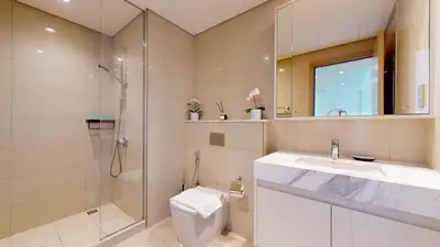 a bathroom with a toilet and a shower and a sink at Vacationer I Modern 1 Bed High-Floor Stay I City Skyline View I Burj Royale I Downtown in Dubai
