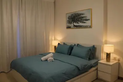 a bedroom with a bed with a towel on it at Bright and beautiful one bedroom apartment close to metro and beach in Dubai