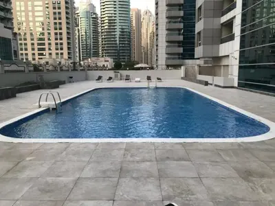 a large swimming pool on top of a building at Bright and beautiful one bedroom apartment close to metro and beach in Dubai