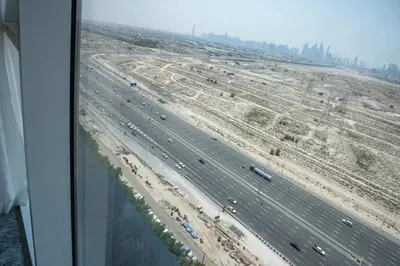 an overhead view of a highway with a construction site at Escape24 Cozy Studio with City View in JVC in Dubai