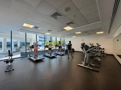 a group of people in a gym with tread machines at Stylish Studio with Premium Features in Marina in Dubai