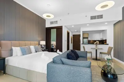 a bedroom with a bed and a couch and a table at Stylish Studio with Premium Features in Marina in Dubai
