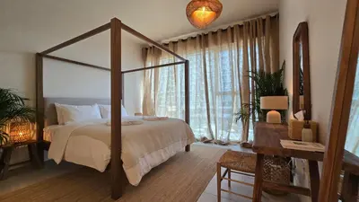 a bedroom with a canopy bed and a desk at Luxury 2BR Biophilic Retreat with Private Jacuzzi, Massage Chair & Infinity Pool in Dubai