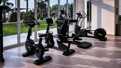 a gym with treadmills and ellipticals in a building at Luxury 2BR Biophilic Retreat with Private Jacuzzi, Massage Chair & Infinity Pool in Dubai