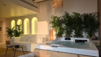 a living room with a jacuzzi tub in the middle of the room at Luxury 2BR Biophilic Retreat with Private Jacuzzi, Massage Chair & Infinity Pool in Dubai