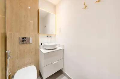 a bathroom with a white toilet and a sink at What a view - very close to DMCC metro station in Dubai