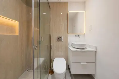 a bathroom with a toilet and a sink and a shower at What a view - very close to DMCC metro station in Dubai