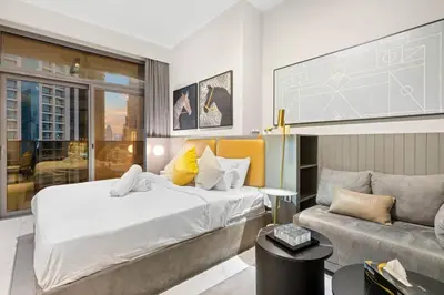 a bedroom with a large bed and a couch at FIRST CLASS Studio Stylish Haven in Dubai