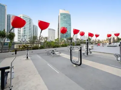 a group of red umbrellas on a roof in a city at FIRST CLASS Studio Stylish Haven in Dubai