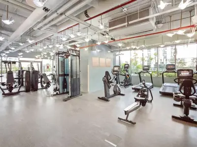 a gym with several treadmills and cardio machines at FIRST CLASS Studio Stylish Haven in Dubai