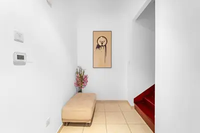 a room with a bench and a picture on the wall at FIRST CLASS 2BR Elite Urban Retreat in Dubai
