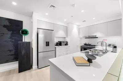 a kitchen with white cabinets and a white counter top at FIRST CLASS 3BR Trendy Urban Hideaway in Dubai