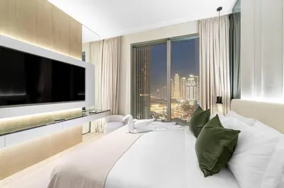 a bedroom with a large white bed with a large window at FIRST CLASS 3BR Trendy Urban Hideaway in Dubai
