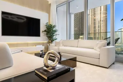 a living room with a couch and a tv at FIRST CLASS 3BR Trendy Urban Hideaway in Dubai