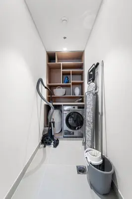 a kitchen with a washing machine and a microwave at FIRST CLASS 3BR Trendy Urban Hideaway in Dubai