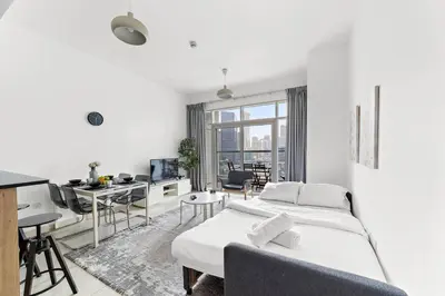 a white bedroom with a bed and a desk at Luxury 2BR with Stunning Dubai Marina Views Near JBR Beach in Dubai