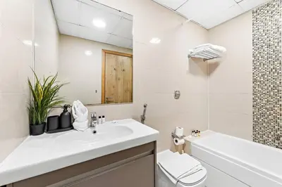 a bathroom with a sink and a toilet and a mirror at Luxury 2BR with Stunning Dubai Marina Views Near JBR Beach in Dubai