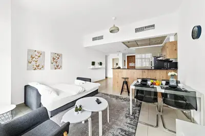 a living room with a couch and a table at Luxury 2BR with Stunning Dubai Marina Views Near JBR Beach in Dubai