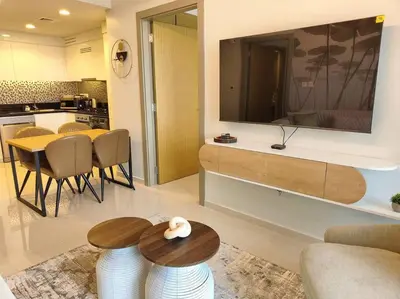 a living room with a large tv on the wall at Upgraded Downtown Dubai 2 BD in Dubai