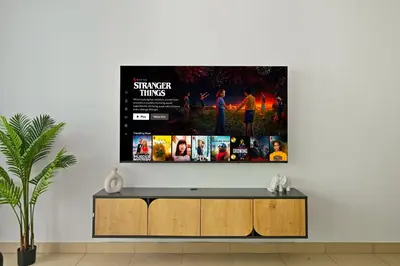 a living room with a tv on a wall at Incredible downtown location in Dubai