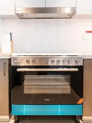 a stainless steel oven in a kitchen at Burj Khalifa Bliss I 4 bedroom Apartments I Burj Khalifa & Fountain Views I Free Gym, Pool, Parking, Wi-Fi and PS5 I by Skyline Serenity in Dubai