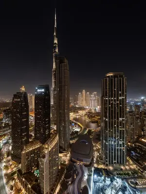 a city skyline at night with a tall building at Burj Khalifa Bliss I 4 bedroom Apartments I Burj Khalifa & Fountain Views I Free Gym, Pool, Parking, Wi-Fi and PS5 I by Skyline Serenity in Dubai