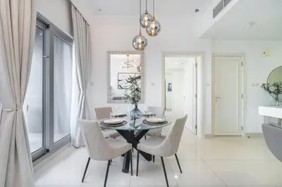 a dining room with a glass table and chairs at New Listing & Burj Khalifa View & Dubai Mall in Dubai