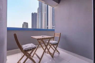 a table and two chairs on a balcony with a city at New Listing & Burj Khalifa View & Dubai Mall in Dubai