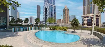 a swimming pool with a city skyline in the background at Easy access to Metro - 1BR in Central Park, DIFC - Allsopp&Allsopp in Dubai