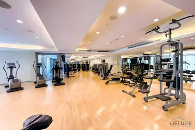 a gym with treadmills and elliptical machines at Burj Khalifa Lake Vicinity Perfect 1BR Escape, Residences 7, Downtown Dubai by Deluxe Holiday Homes in Dubai