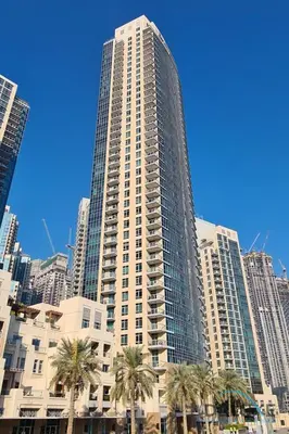 a tall building with palm trees in front of it at Burj Khalifa Lake Vicinity Perfect 1BR Escape, Residences 7, Downtown Dubai by Deluxe Holiday Homes in Dubai