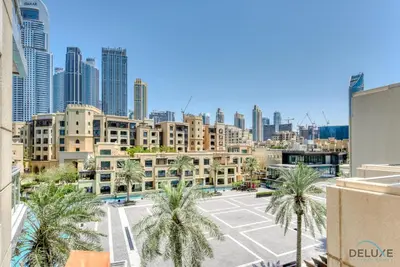 a view of a city with palm trees and buildings at Burj Khalifa Lake Vicinity Perfect 1BR Escape, Residences 7, Downtown Dubai by Deluxe Holiday Homes in Dubai