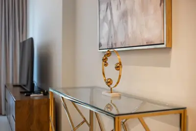 a glass table with a trophy on top of it at Apartment in Downtown Dubai in ACT I ACT II - 5 min walk to Dubai Mall in Dubai