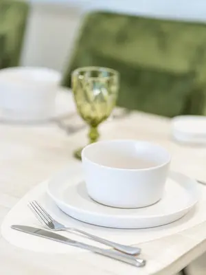 a table with a white bowl and a glass on it at Stunning Two Bedroom Apartment with Private Balcony & Burj Khalifa by Luxury Space in Dubai