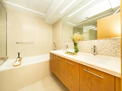 a bathroom with a sink and a tub and a mirror at Stunning Two Bedroom Apartment with Private Balcony & Burj Khalifa by Luxury Space in Dubai