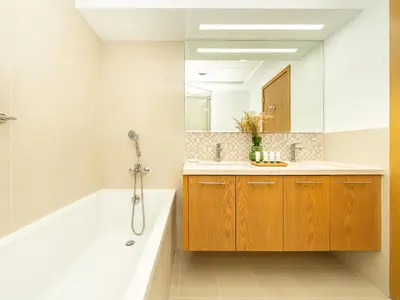 a bathroom with a tub and a sink and a mirror at Stunning Two Bedroom Apartment with Private Balcony & Burj Khalifa by Luxury Space in Dubai
