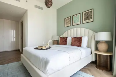 a bedroom with a large white bed with a white bedspread at Frank Porter - Downtown Views II Tower 1 in Dubai