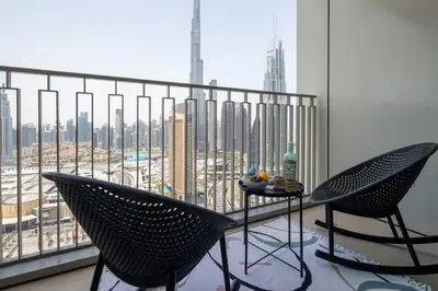 a balcony with a table and chairs and a view of a city at Frank Porter - Downtown Views II Tower 1 in Dubai