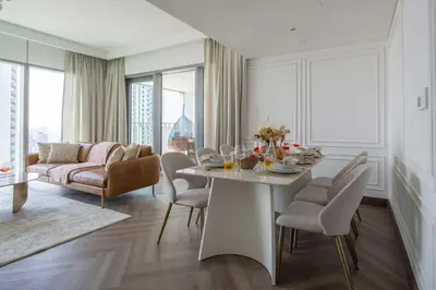 a living room with a white table and chairs at Frank Porter - Downtown Views II Tower 1 in Dubai