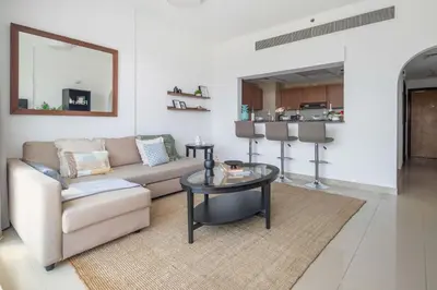 a living room with a couch and a table at Frank Porter - Golf Tower 3 in Dubai
