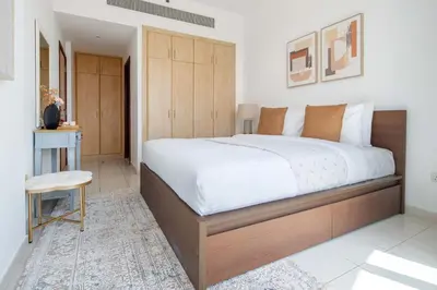 a bedroom with a large bed and a table at Frank Porter - Golf Tower 3 in Dubai