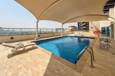 a swimming pool on the roof of a building at Frank Porter - Golf Tower 3 in Dubai