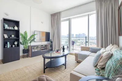 a living room with a couch and a table at Frank Porter - Golf Tower 3 in Dubai