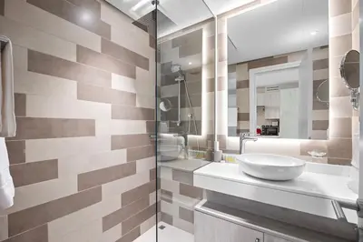 a bathroom with a sink and a mirror at Goldbest - Seven Palm 4ppl in Dubai