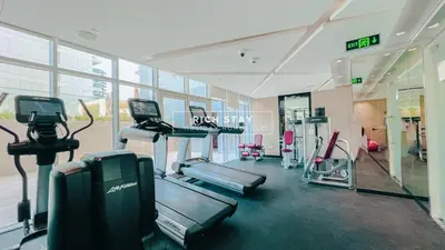 a gym with treadmills and machines in a building at Modern loft Studio in Damac Majestine,Business Bay in Dubai