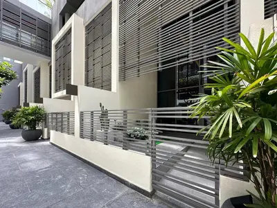 a facade of a building with plants in a courtyard at Trophy - Elevated Living in Luxurious Business Bay Loft in Dubai