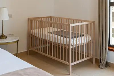 a crib in a bedroom next to a bed at Prime Spacious 5 Plus 1 BR Apt On JBR Beach near Metro ,Walk to The Mall, Dining & Entertainment - By Sunkissed Holiday Homes in Dubai