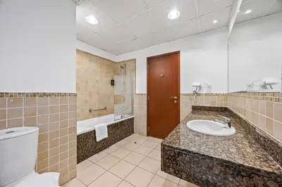 a bathroom with a toilet and a sink at Prime Spacious 5 Plus 1 BR Apt On JBR Beach near Metro ,Walk to The Mall, Dining & Entertainment - By Sunkissed Holiday Homes in Dubai