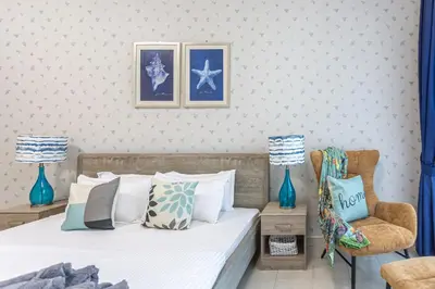 a bedroom with a bed and a chair at Stunning 1 Bedroom Apartment in Dubai Marina in Dubai