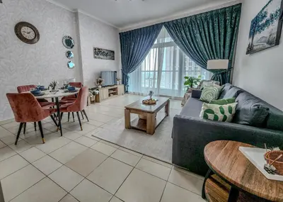 a living room with a couch and a table at Stunning 1 Bedroom Apartment in Dubai Marina in Dubai